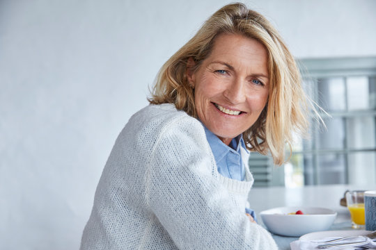 Portrait smiling senior woman at breakfast on patio