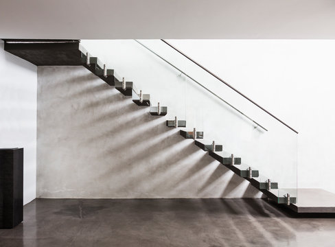 Modern, minimalist floating staircase in home showcase interior foyer
