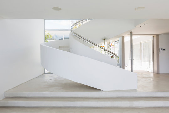White spiral staircase in modern luxury home showcase interior