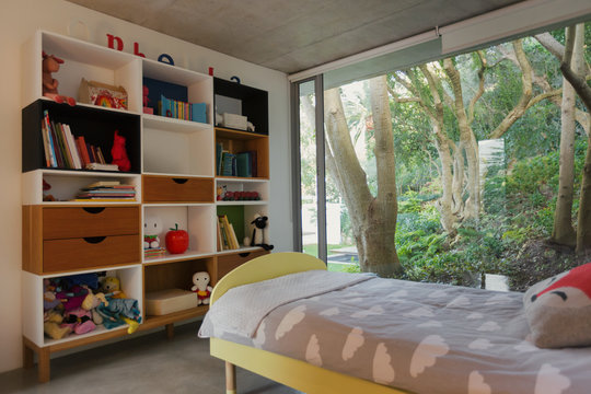 Home showcase interior child‚Äôs bedroom with view of trees in garden