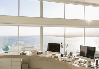 Sunny, tranquil modern luxury home showcase interior home office with ocean view