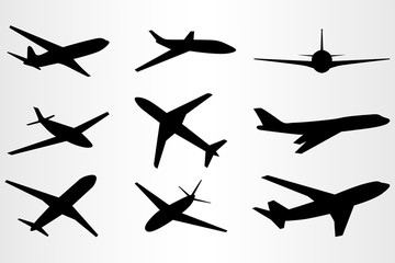 Set of nine stylized silhouettes of flying planes. Set for travel needs.