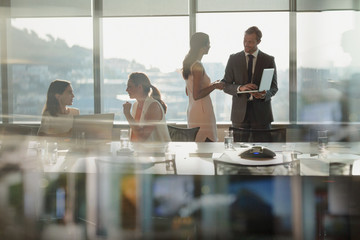 Business people talking, using laptop in conference room meeting