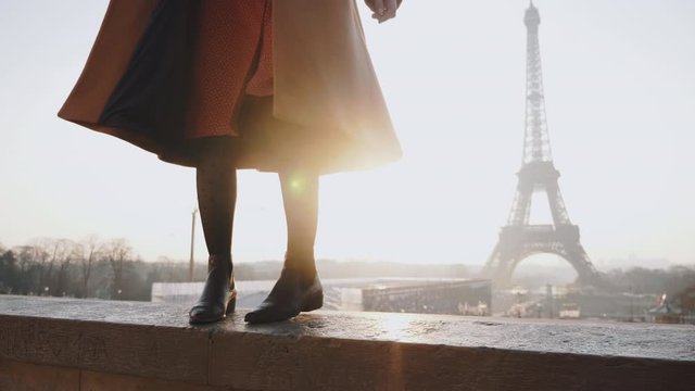 Close-up legs of beautiful tourist woman posing, walking left and right at romantic Eiffel Tower view Paris slow motion.