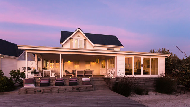 Tranquil white home showcase exterior at dusk