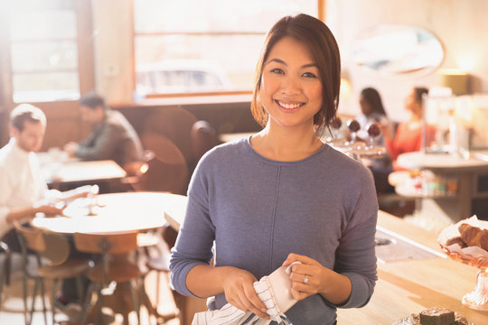 Portrait smiling female barista in cafe