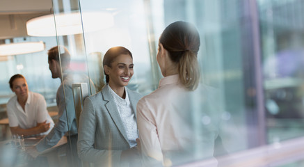 Smiling businesswomen talking in office