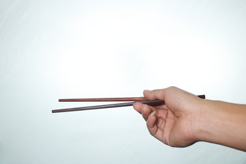 hand with chopsticks isolated on white background