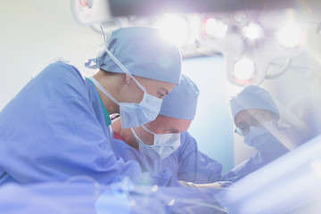 Focused surgeons performing surgery in operating room