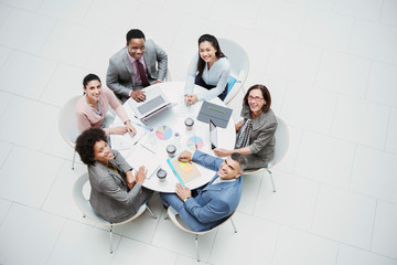 High angle portrait smiling, confident business people meeting at round table