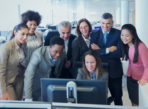 Business People Meeting Around Computer In Office