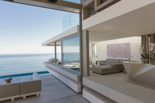 Modern, luxury home showcase living room and patio with ocean view