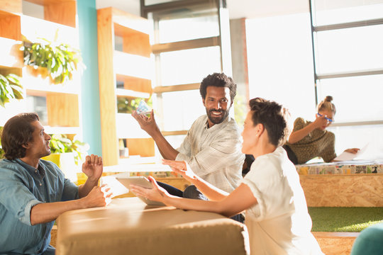 Innovative entrepreneurs examining glass cube prototype
