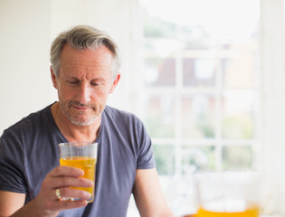 Mature man drinking juice