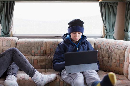 Teenage boy using digital tablet in motor home