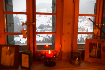 Christmas candle in window overlooking tranquil snowy landscape, Forclaz, Switzerland