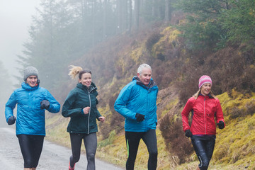 Family jogging in woods