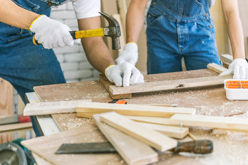 Woodworker in the shop. Carpenter is marking the workpieces for woodturning project. Making a handmade bowls. Craftsman skills concept.