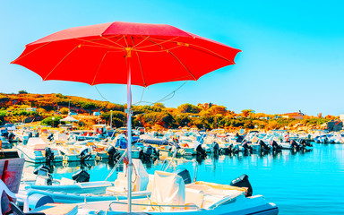 Old Sardinian Port and marina with ships at Mediterranean Sea in city of Villasimius in South Sardinia Island Italy in summer. Cityscape with Yachts and boats
