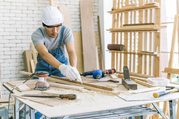 Carpenter is using a tool for woodworking. Man with carpenters tools construction concept.