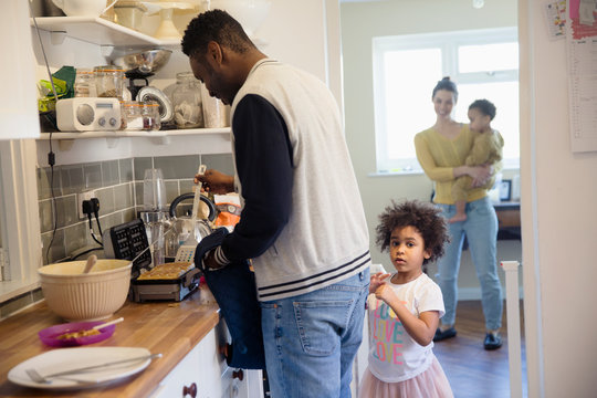 Family baking waffles in kitchen