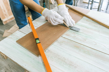 Construction Worker Using Drill To wood. closeup of carpenter work with hammer tool.