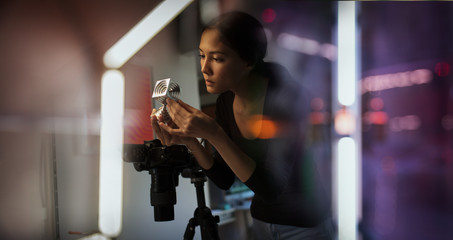 Female photographer looking at prototype