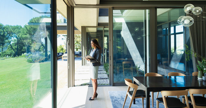 Confident businesswoman working from home, standing in corridor