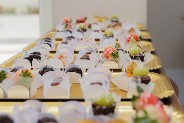 Golden trays side by side with various types of birthday candy.