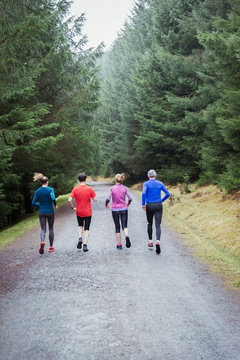 Family jogging in woods