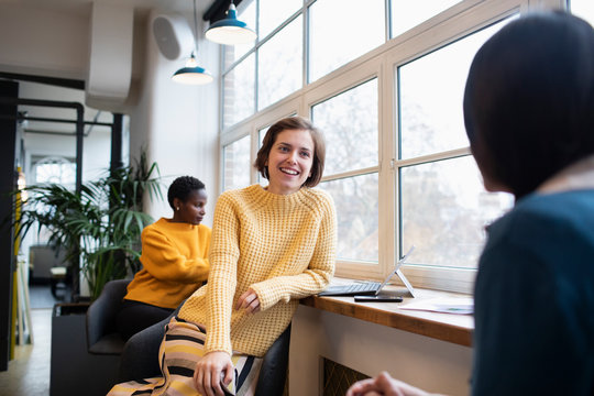 Smiling businesswomen talking in office