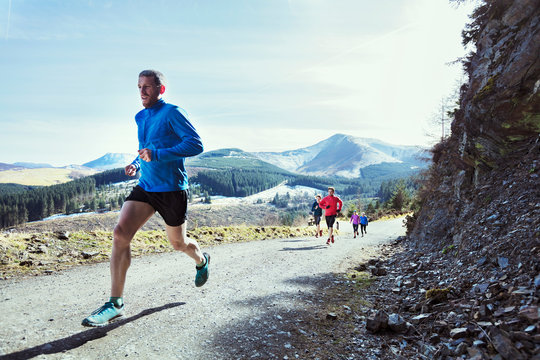 Friends Jogging On Mountain Trail