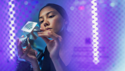 Female innovator examining prototype