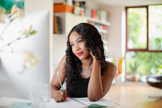 Young woman working at computer in home office