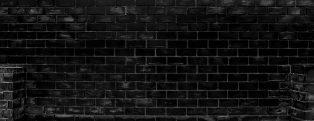 Fototapeta na wymiar black wall surface uses many bricks. Or the old black patterned brick 