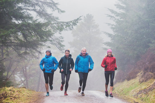 Family jogging in woods
