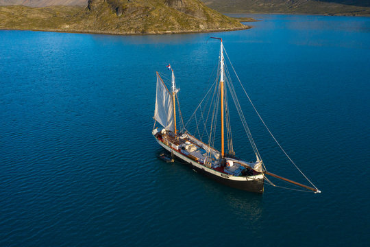 Ship in bay on sunny blue ocean Greenland