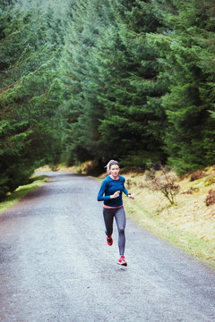 Woman running in woods