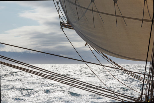 Sailboat sail and rigging over sunny Atlantic Ocean