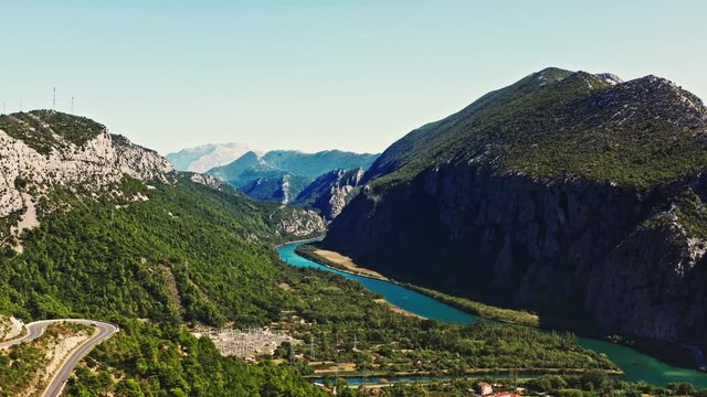 aerial camera rising on a wide shot of a epic mountain scenery on beautiful day