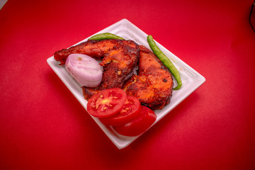 Fried carp fish in oil. Restaurant dishes. Top view. on Red background.