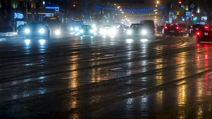 rush hour car traffic on the night street after heavy rain in Minsk city, Belarus