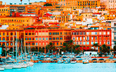Fototapeta na wymiar Old Sardinian Port with ships at Mediterranean Sea and city of Cagliari, South Sardinia Island in Italy in summer. Cityscape with marina and Yachts and boats in town
