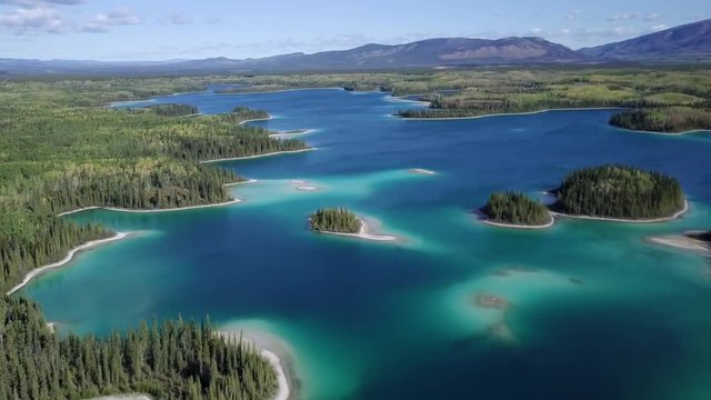 Aerial flying over Boya lake and it&rsquo;s aquamarine waters in the British Columbia, Canada