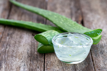Jelly aloe vera in bowl on wooden table.