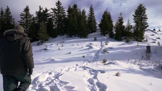 Man goes through snow on the Mountain top - (4K)