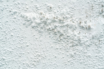 The paint is peeling off the water at cement background. Construction concept.