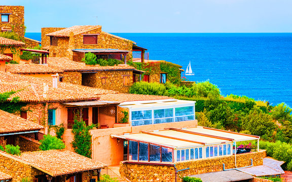Scenery with House and cottages at Capo Coda Cavallo, San Teodoro in Olbia-Tempio province, Sardinia island, in Italy. Mediterranean sea at the background. Tavola island