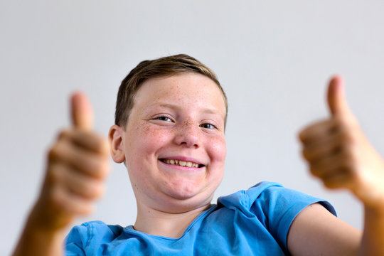 Boy with thumbs up - Powered by Adobe