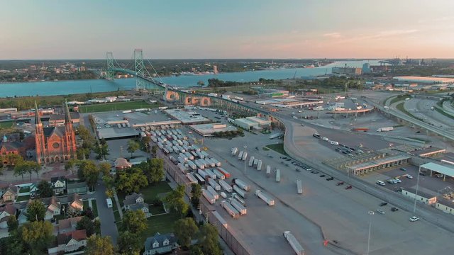 Aerial flying over U.S. Customs and Border Protection for freight trucks crossing the Ambassador bridge. Detroit, Michigan, USA